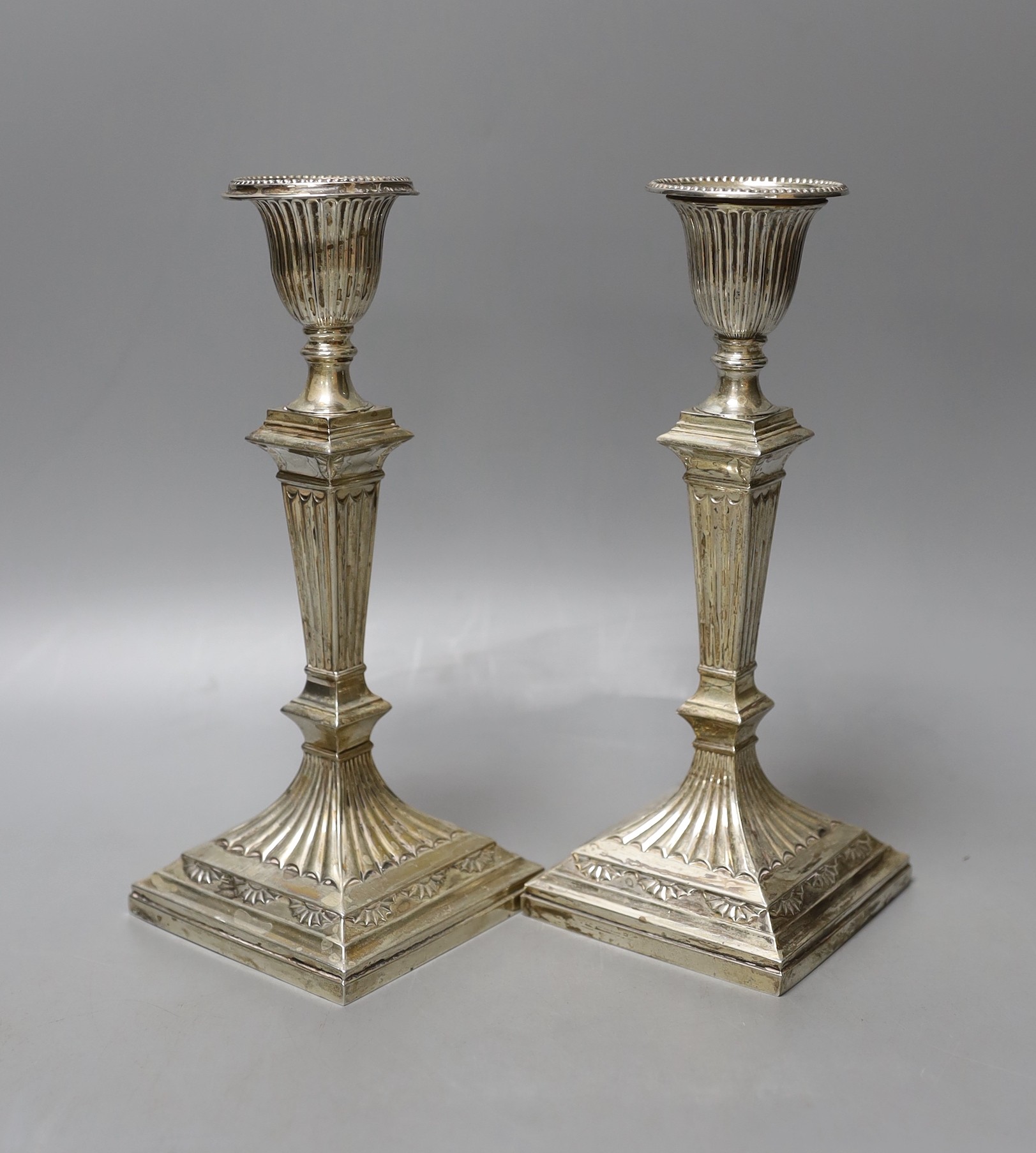 A pair of late Victorian silver candlesticks, by Hawksworth, Eyre & Co, Sheffield, 1894, 21.5cm, weighted.